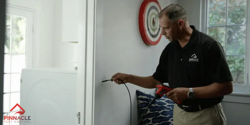 A man using a screwdriver to fix a door.
